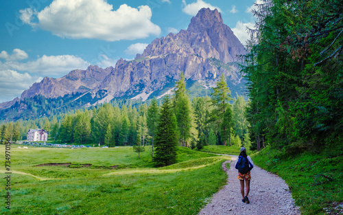 young women hiking at the dolomites mountains in Italy. Italian alps