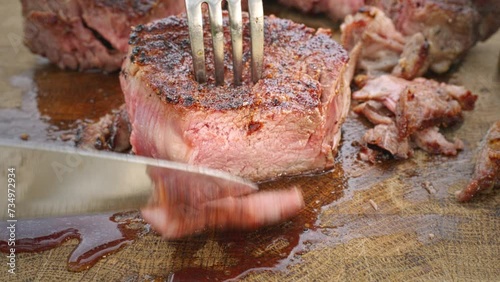Grilled veal steak is cut into pieces. Meat is an excellent source of essential vitamins and elements. photo