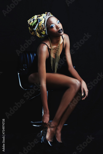 Black woman, fashion and portrait with confidence, head dress and makeup in studio. Cosmetics, trendy and beauty with African female person from Kenya with traditional hair wrap with dark background