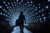 individual walking through a tunnel with led stars, simulating spacewalk
