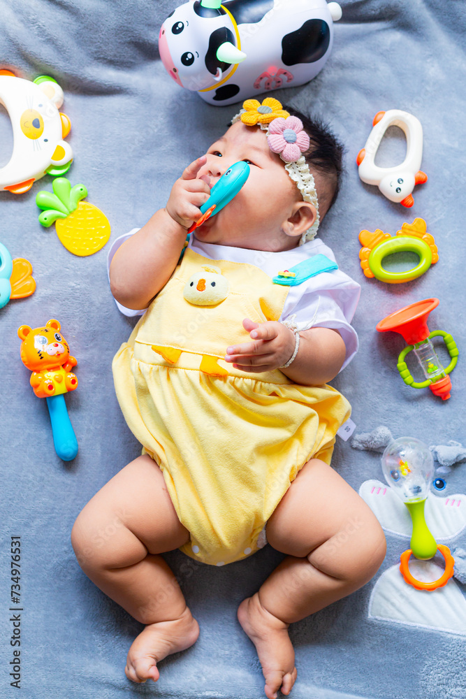 Obraz premium Baby in cute outfit with toys,Little girl 3-6 months old in cute outfits