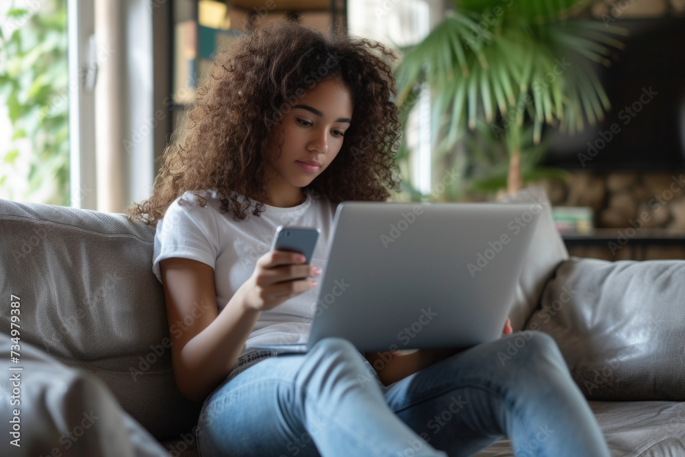 Young ethnic Latin girl teenager uses laptop to chat with friends and use social networks on Internet sits on sofa with portable computer on lap. Digital addiction Young ethnic Latin girl teenager uses laptop to chat with friends and use social networks on Internet sits on sofa with portable computer on lap. Digital addiction
