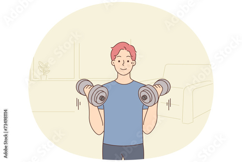 Young man with barbells train at home