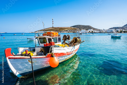 Colorful fishing boat on azure sea in Pollonia port, Milos island, Cyclades, Greece photo