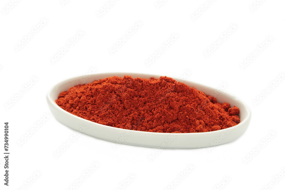 Red sweet paprika powder on plate isolated on white background Red sweet paprika powder on plate isolated on white background