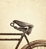 Retro styled image of a vintage weathered leather bicycle seat