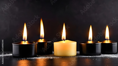 closeup of burning candles on an abstract black background contemplates the celebration mood. Christmas candles on a dark background
