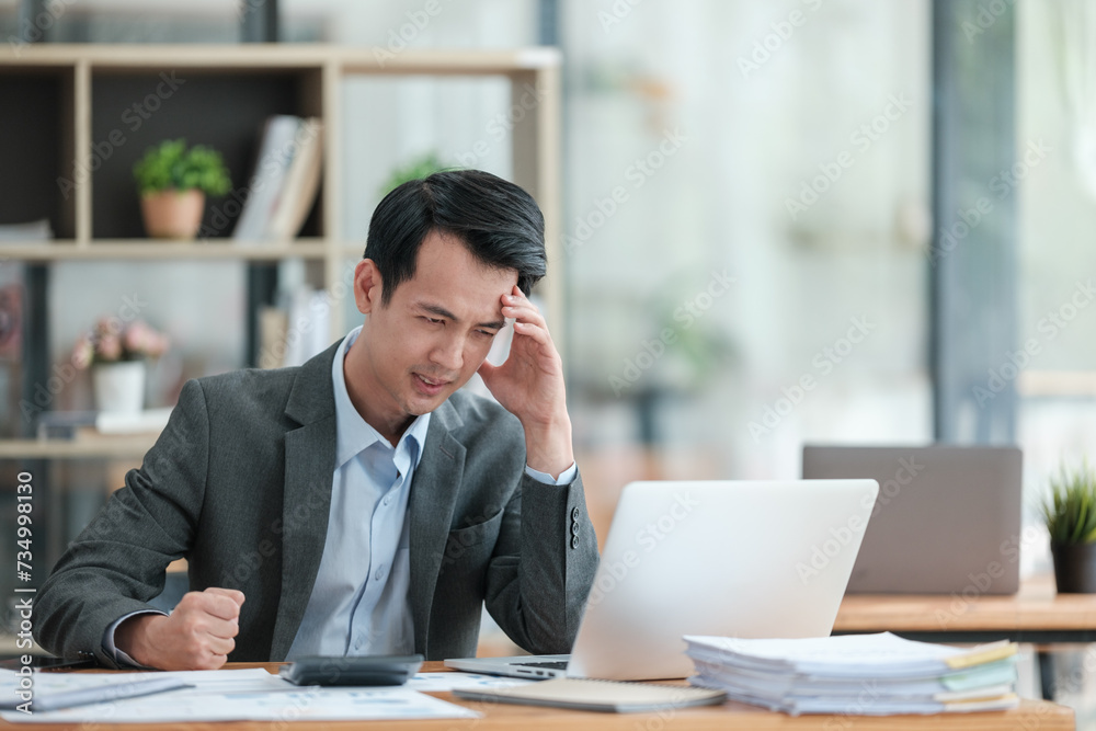 Young Stressed Out Businessman Using Laptop Computer in Modern Office. Manager Thinks About Successful Financial Ideas. Happy Man Smiling About Finding Problem Solving Solutions for Company. Young Stressed Out Businessman Using Laptop Computer in Modern Office. Manager Thinks About Successful Financial Ideas. Happy Man Smiling About Finding Problem Solving Solutions for Company.