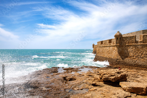 La Caleta Beach, Balneario de la Palma Building and Castle of San Sebastian at sunset - Cadiz, Andalusia, Spain photo