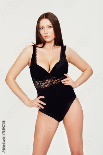 Body, beauty or portrait of woman with lingerie in studio for wellness, care or glowing skin on white background. Bodysuit, underwear or female model with confidence, attitude or classy style choice