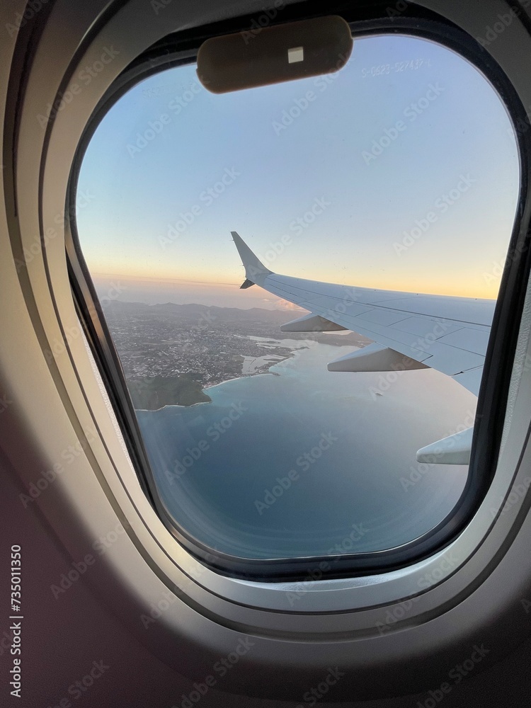 view from airplane window flying over the Caribbean