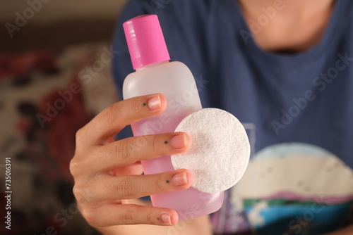 woman using acetone and cotton for care