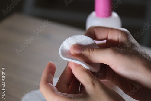 woman using acetone and cotton for care photo