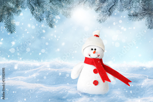 Cute decorative snowman in hat and scarf outdoors on snowy day, space for text