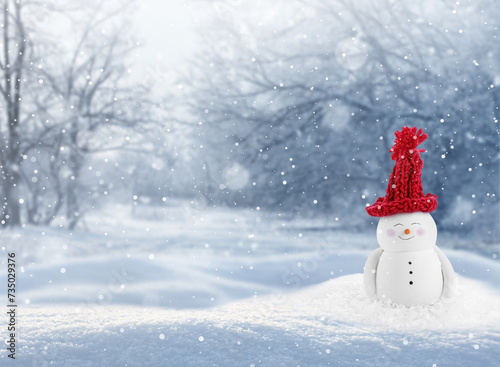 Cute decorative snowman in red hat outdoors on snowy day, space for text