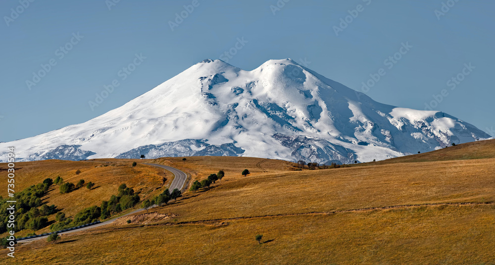 Russia, the Elbrus region. Amazing view of the snow-capped peaks of Elbrus (5642 m) from the side of the Gily-Su tract.