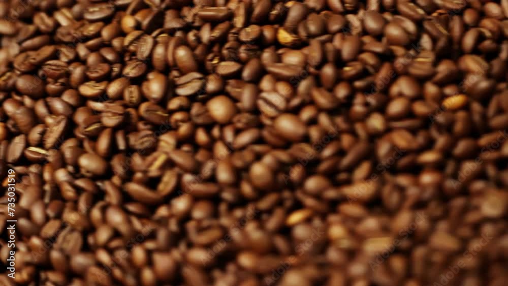 Aromatic brown coffee beans rotating in special cooler after roasting, in slow motion Aromatic brown coffee beans rotating in special cooler after roasting, in slow motion