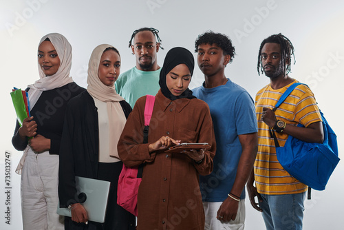 Group of diverse students engages in modern educational practices, utilizing a variety of technological tools such as laptops, tablets, and smartphones against a clean white background, exemplifying