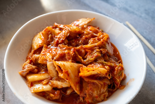 kimchi in fresh white bowl close-up on gray background 