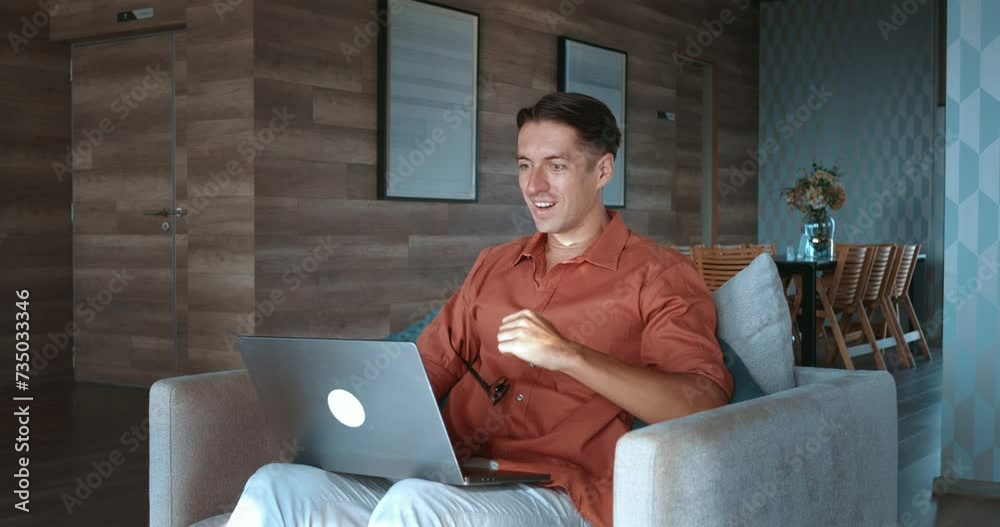 A man glasses, seated laptop, wins, intense emotions. surge positive emotions, projects highlighting power emotions success moments Emotions run high this victory scene perfect emotional storytelling.