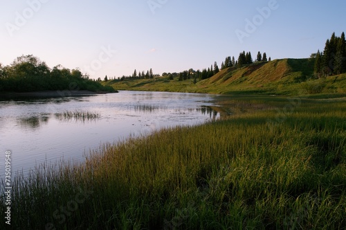 evening river hill bushes grass lilac sky