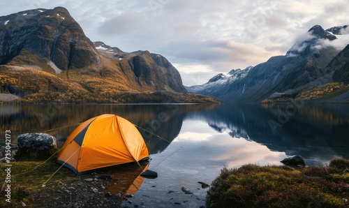 tent on the lake with mountains in the background