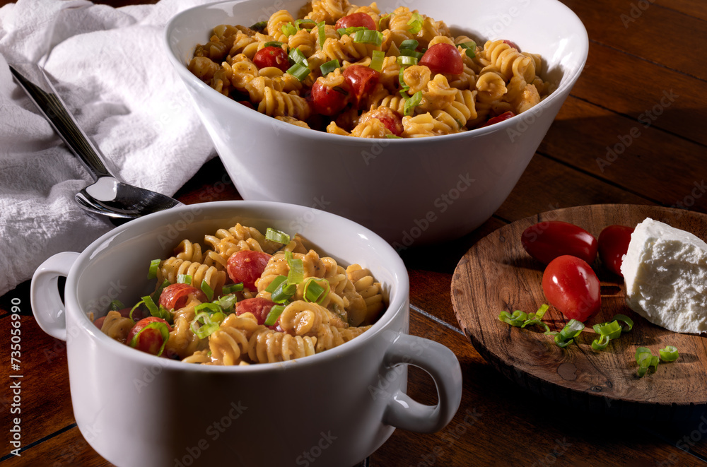 Spiral macaroni summer salad with tomatoes in serving bowl Spiral macaroni summer salad with tomatoes in serving bowl