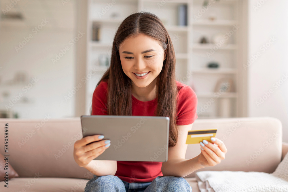 Joyful Asian Woman Using Digital Tablet And Credit Card For Online Shopping Joyful Asian Woman Using Digital Tablet And Credit Card For Online Shopping