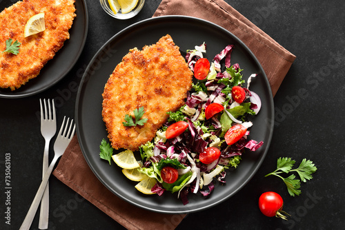 Chicken schnitzel and vegetable salad on plate