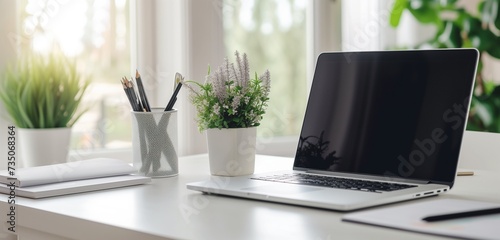 Elegant laptop, documents, pencil holder on white desk; contemporary workspace, calming lavender tones.