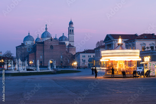 Veduta serale della basilica di Santa Giustina di Padova e della antica giostra in movimento photo