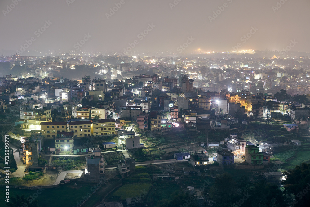 Aerial night Kathmandu cityscape with lot of low rise buildings with dim lights of nighttime city, Kathmandu twilight dreamscape with tranquil ambiance and serenity of night