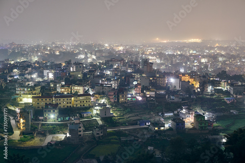 Aerial night Kathmandu cityscape with lot of low rise buildings with dim lights of nighttime city  Kathmandu twilight dreamscape with tranquil ambiance and serenity of night