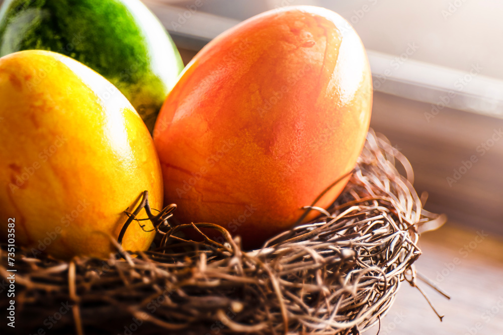 Obraz na plátně Close-up colorful Easter eggs in a nest. Easter concept