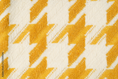 Texture of knitted yellow milk fabric close-up at an angle. The concept of materials for tailoring and making products. Image for your design