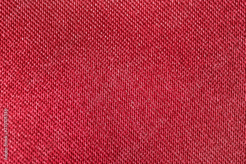 Close-up Texture of polyester fabric of red color with shine. Background for your design. Materials for sewing