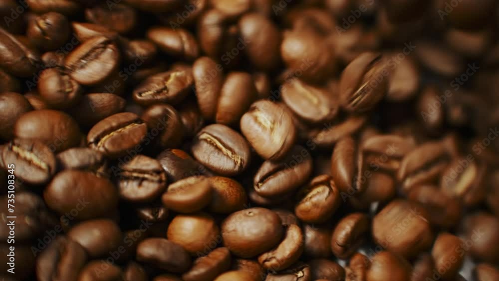 Aromatic brown coffee beans rotating in special cooler after roasting, in slow motion Aromatic brown coffee beans rotating in special cooler after roasting, in slow motion