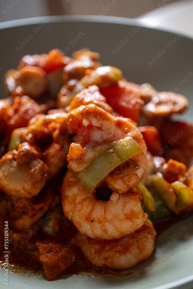 Shrimp with tomatoes on a baking plate, close-up