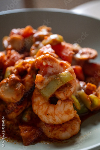 Shrimp with tomatoes on a baking plate, close-up