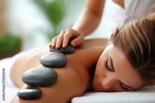 Woman enjoying exotic hot stones spa massage, relax 