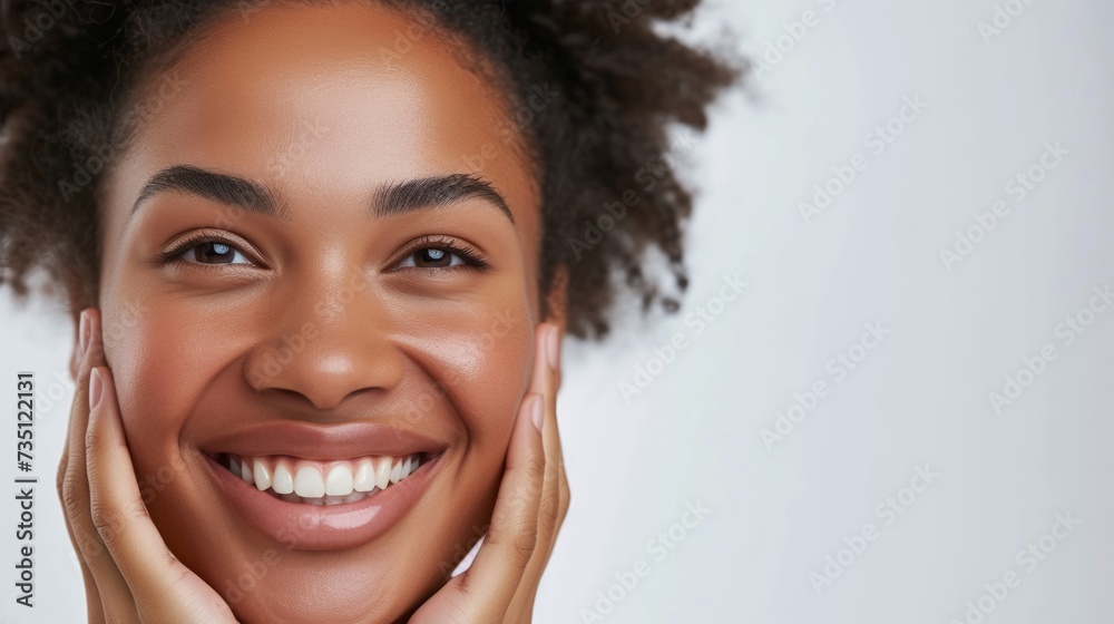 Radiant Young Woman With a Joyful Smile Holding Her Cheeks Radiant Young Woman With a Joyful Smile Holding Her Cheeks
