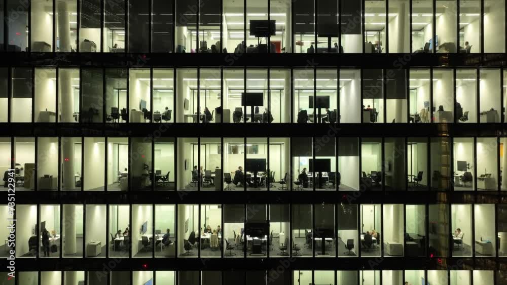 Big glowing windows in modern office buildings at night 4k