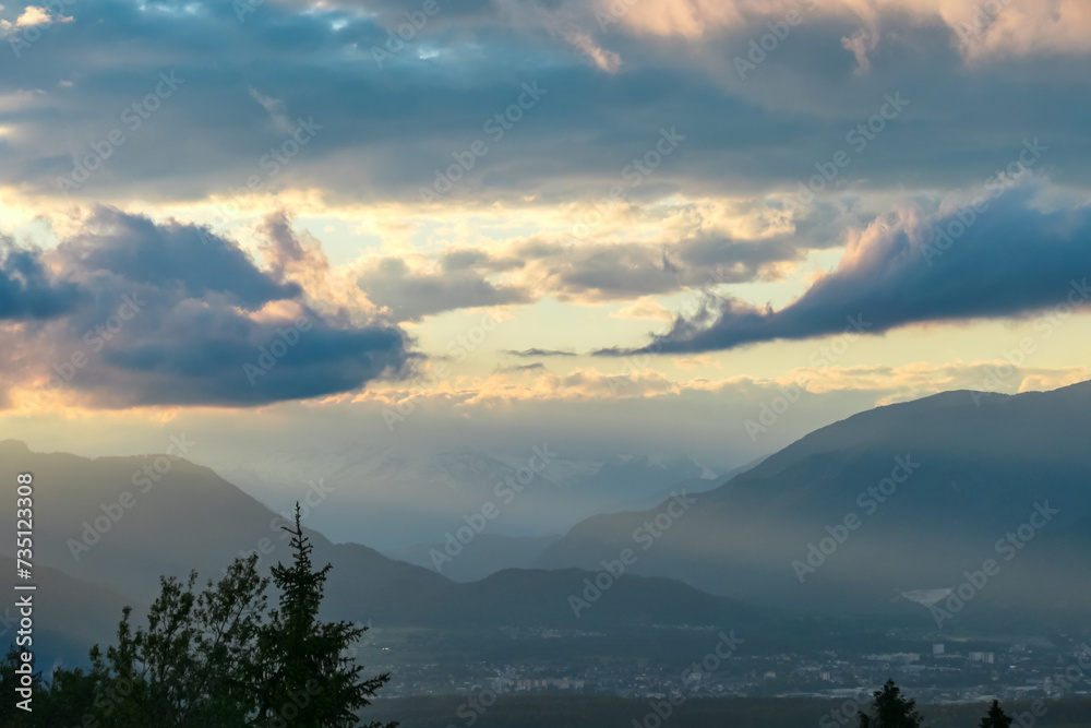 Scenic sunset view of mountain range Bleiberg Erzberg seen from Altfinkenstein, Baumgartnerhoehe, Carinthia, Austria. Tranquility on hiking trail. Overlooking Villach area surrounded by Austrian Alps