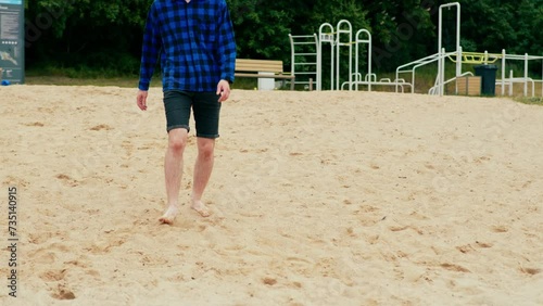 a sad guy walks along the beach and falls to his knees