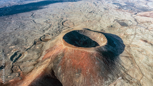 Aerial view from above of the crater Calderon Hondo. Calderon Hondo is a volcanic caldera in the sland of Fuerteventura, Canary Islands. photo