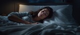 Top view of woman lying on the bed trying to sleep and changing sleep positions Tossing and turning at night Woman suffering from insomnia sleeping problems or sleep disorders Woman can t sleep
