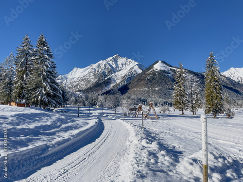 Winter hiking trail in a snow-covered landscape in Pertisau at Lake Achensee.