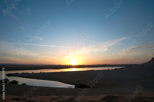 sunset scene on Magic Lake  where water comes out of deep earth   forms a lake in a heart of dessert in fayoum   Egypt.