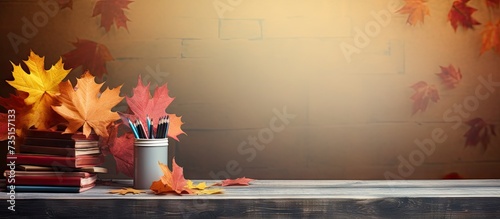 school supplies on the table autumn still life with textbooks and yellow maple leaves. Creative Banner. Copyspace image