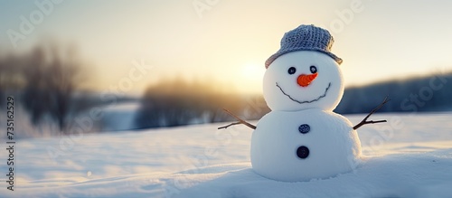 Snowman with carrot nose and coal eyes on snowy field. Creative Banner. Copyspace image